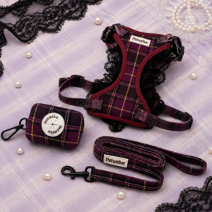 Petwelve maroon purple plaid dog set with black lace trim: harness, leash and poop bag dispenser with pearl accents, laid on lavender fabric with lace and pearls, elegant feminine style